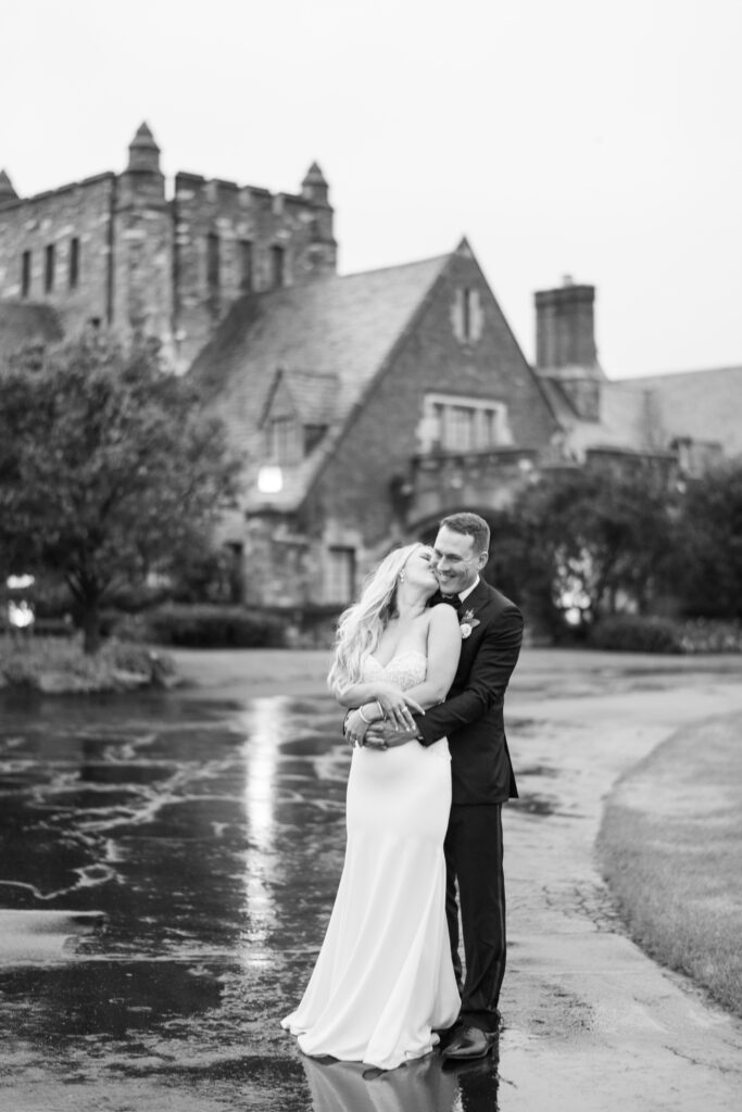 bride and groom kissing in front of their wedding at park country club in williamsville ny